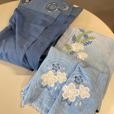 Blue fabric shower curtain and towels