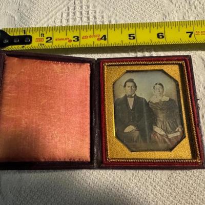 Sale Photo Thumbnail #394: Antique Album as is over 100 years old 11" x 8.5" x 2.5", 5 photo frames. 2 of the frames are 3.5" x 4", and 3 frames are 2.5" x 2 3/4" x 1/4".  An as is dictionary and religious on wood Mary and child.  8 items total.  Daguerreotypes. Ambrotype.  Tintype