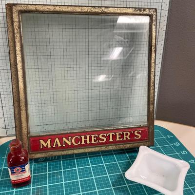 Vintage Manchester’s countertop buscuit display with mercurochrome bottle and milk glass ashtray