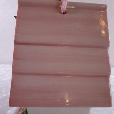 Mudpie ceramic birdhouse decorated with pink rosettes