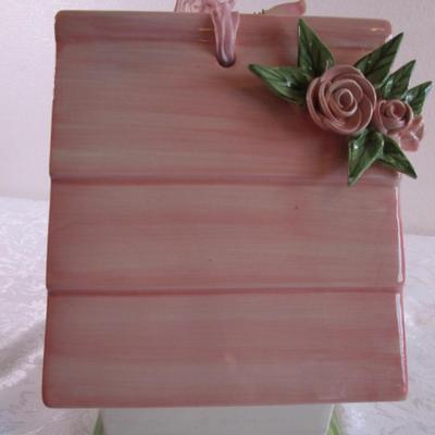 Mudpie ceramic birdhouse decorated with pink rosettes