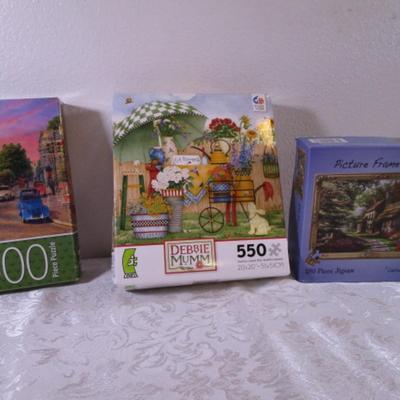 1 Picture Frame puzzle, 1 Siene Sunset puzzle, 1 Debbie Mumm puzzle