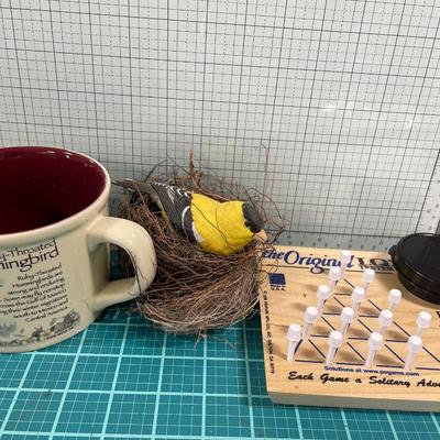 Game, bird in nest and mug