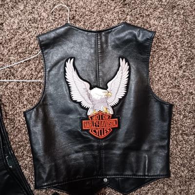 LADIES LEATHER VEST W/STURGIS PEWTER PINS AND HARLEY DAVIDSON PATCH PLUS LEATHER PANTS