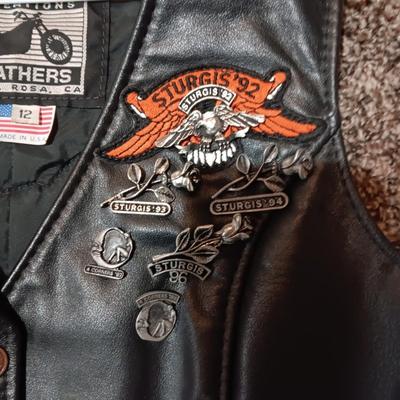 LADIES LEATHER VEST W/STURGIS PEWTER PINS AND HARLEY DAVIDSON PATCH PLUS LEATHER PANTS