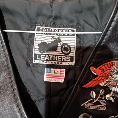 LADIES LEATHER VEST W/STURGIS PEWTER PINS AND HARLEY DAVIDSON PATCH PLUS LEATHER PANTS