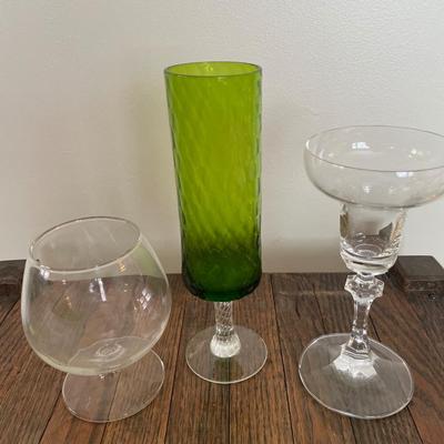 Clear drinking glasses and green glass vase