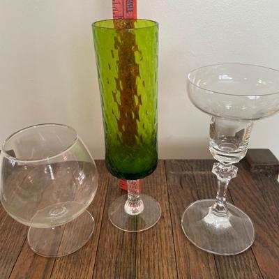 Clear drinking glasses and green glass vase