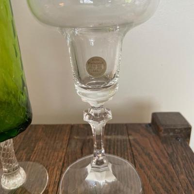 Clear drinking glasses and green glass vase