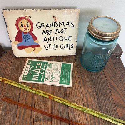 Knitting needles, blue ball jar, sign and mounting corners