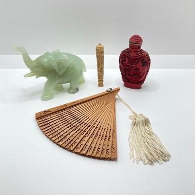 LOT 58: Vintage Asian Carved Collection - Cinnabar snuff bottle, Jade Elephant, Hand Held Filigree Wood Fan and More