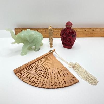 LOT 58: Vintage Asian Carved Collection - Cinnabar snuff bottle, Jade Elephant, Hand Held Filigree Wood Fan and More