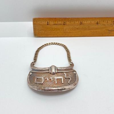 LOT 173: Vintage Sterling Silver "To Life" Celebration Liquor Bottle Decanter Tag - TW 68.06g