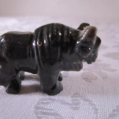 Carved stone buffalo figurine, round ceramic buffalo disc