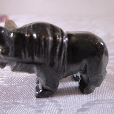 Carved stone buffalo figurine, round ceramic buffalo disc
