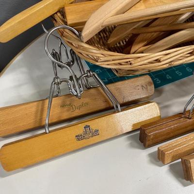 Basket of wood hangers & bag full of clothes pins