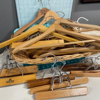 Basket of wood hangers & bag full of clothes pins