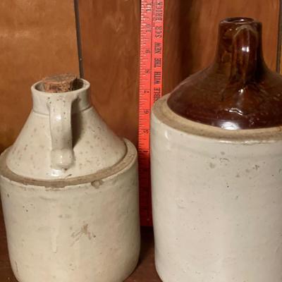 Stamped Minnesota jug with cork and unmarked jug with brown top