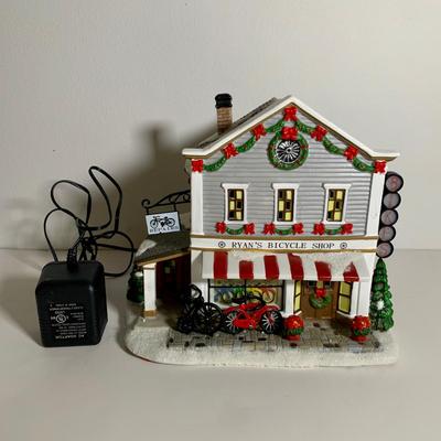 LOT 25 L: St. Nicholas Square Illuminated 2009 "Ryan's Bicycle Shop", 2010 "The Coffee Grounds", Department 56...