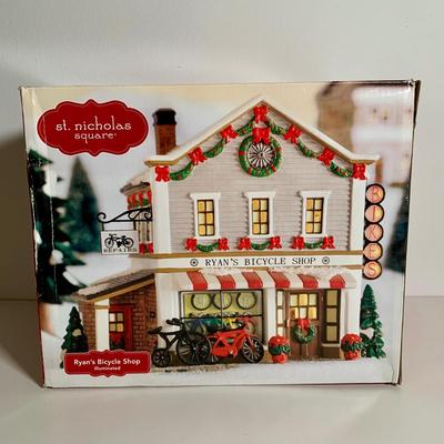 LOT 25 L: St. Nicholas Square Illuminated 2009 "Ryan's Bicycle Shop", 2010 "The Coffee Grounds", Department 56...