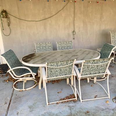 LOT 129 O: Large Outdoor Green Leaf Motif Patio Set: Glass Top Table w/ 6 Chairs, 2 Glass Top Side Tables w/ Glider, Lounger, & Ottoman
