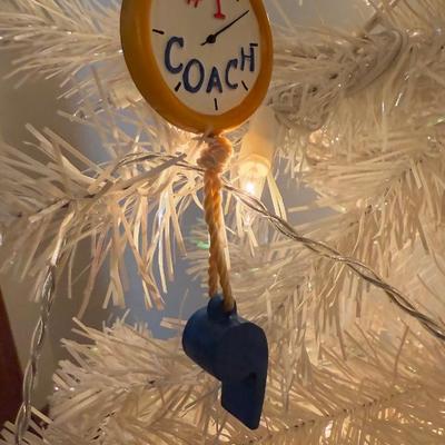 LOT 174D: Eagles Christmas Collection - White 42” Tree w/ Football Or aments, Snowglobe, Santa Hat & More