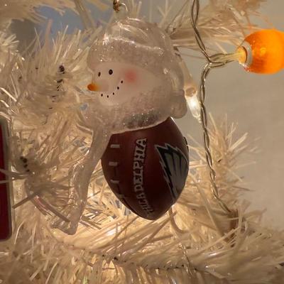 LOT 174D: Eagles Christmas Collection - White 42” Tree w/ Football Or aments, Snowglobe, Santa Hat & More