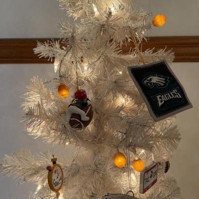 LOT 174D: Eagles Christmas Collection - White 42” Tree w/ Football Or aments, Snowglobe, Santa Hat & More