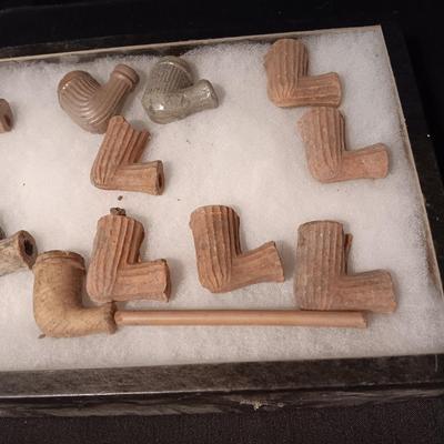 NATIVE AMERICAN PARTIALLY PIECES OF PEACE PIPES IN A DISPLAY CASE
