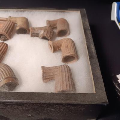 NATIVE AMERICAN PARTIALLY PIECES OF PEACE PIPES IN A DISPLAY CASE