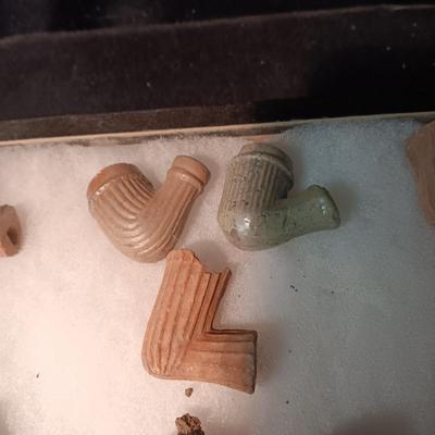 NATIVE AMERICAN PARTIALLY PIECES OF PEACE PIPES IN A DISPLAY CASE