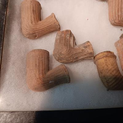 NATIVE AMERICAN PARTIALLY PIECES OF PEACE PIPES IN A DISPLAY CASE