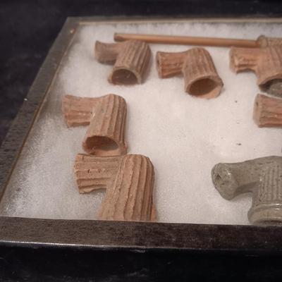 NATIVE AMERICAN PARTIALLY PIECES OF PEACE PIPES IN A DISPLAY CASE