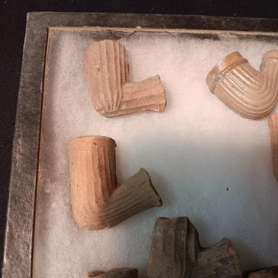 NATIVE AMERICAN PARTIALLY PIECES OF PEACE PIPES IN A DISPLAY CASE