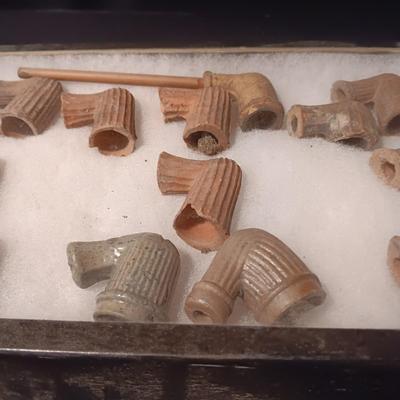 NATIVE AMERICAN PARTIALLY PIECES OF PEACE PIPES IN A DISPLAY CASE