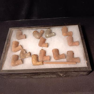 NATIVE AMERICAN PARTIALLY PIECES OF PEACE PIPES IN A DISPLAY CASE