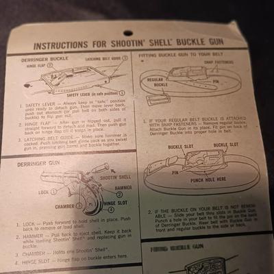 UNOPENED BUCKLE GUN REMINGTON-DERRINGER BY MATTEL ON A BOARD