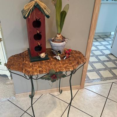 Wicker table with bird house, birds and amaryllis