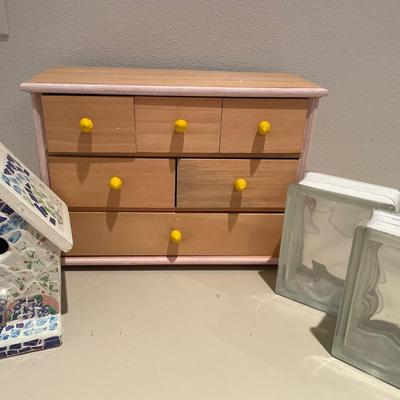 Mosaic birdhouse, wood cabinet, and two clear blocks