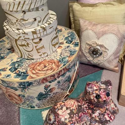 Decorative pillows, boxes and cat