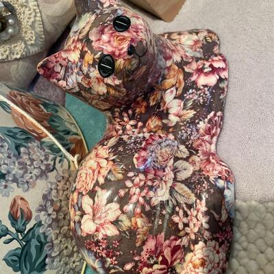 Decorative pillows, boxes and cat