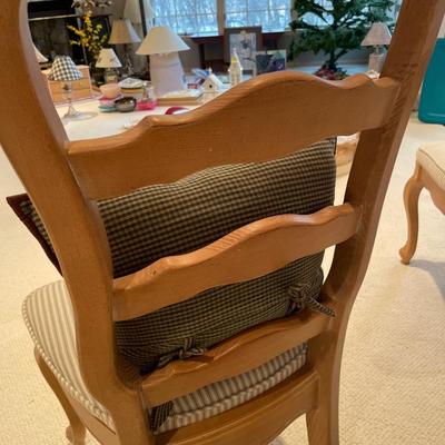 White and tan striped bench and two chairs