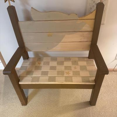Painted wooden bench with wooden cross and wall decor