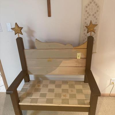 Painted wooden bench with wooden cross and wall decor