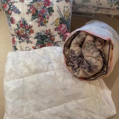 Two flower pattern, comforters, and a mattress pad