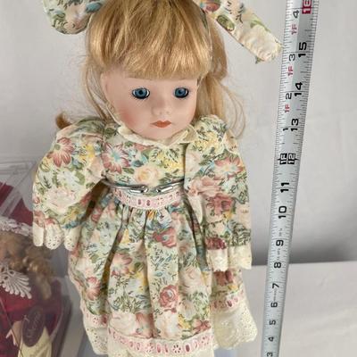 Animated, windup musical doll & 17” porcelain doll