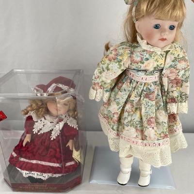 Animated, windup musical doll & 17” porcelain doll