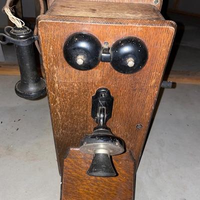 Antique hand crank wall phone with black bells
