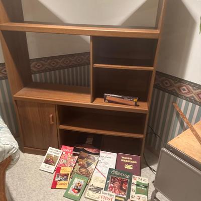 Entertainment center with books and a game.