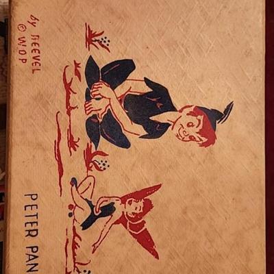 Peter Pan Storage box with vintage doll clothes.